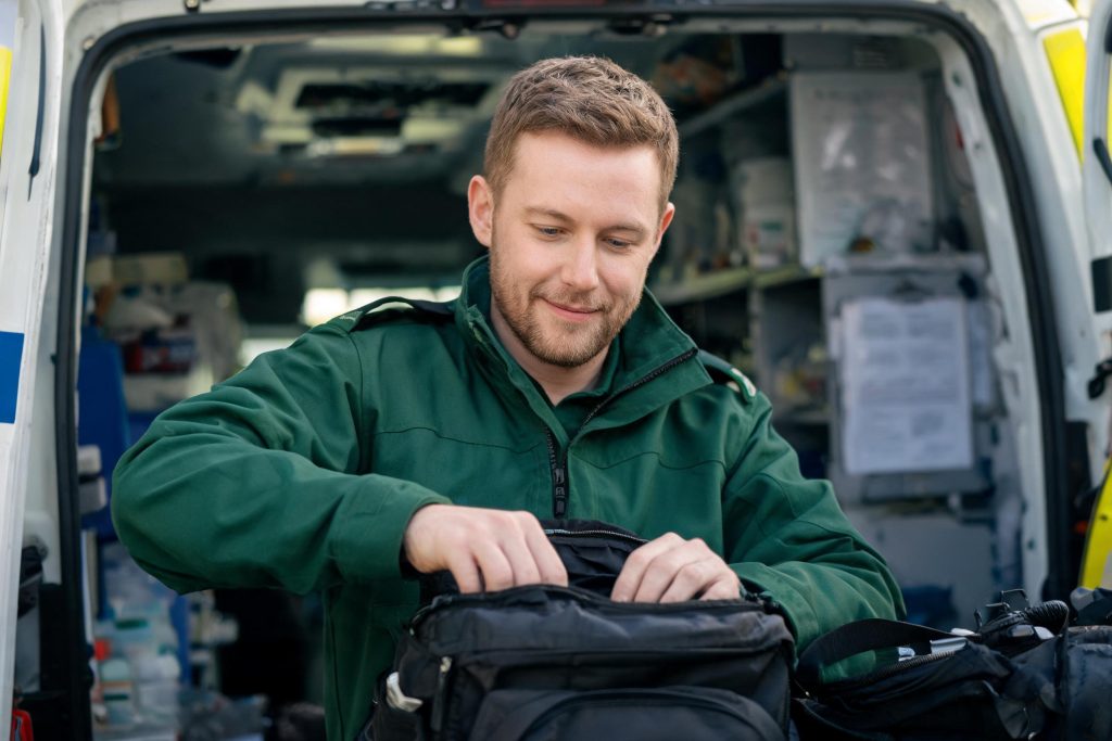 Paramedic checking a response bag in an ambulance
