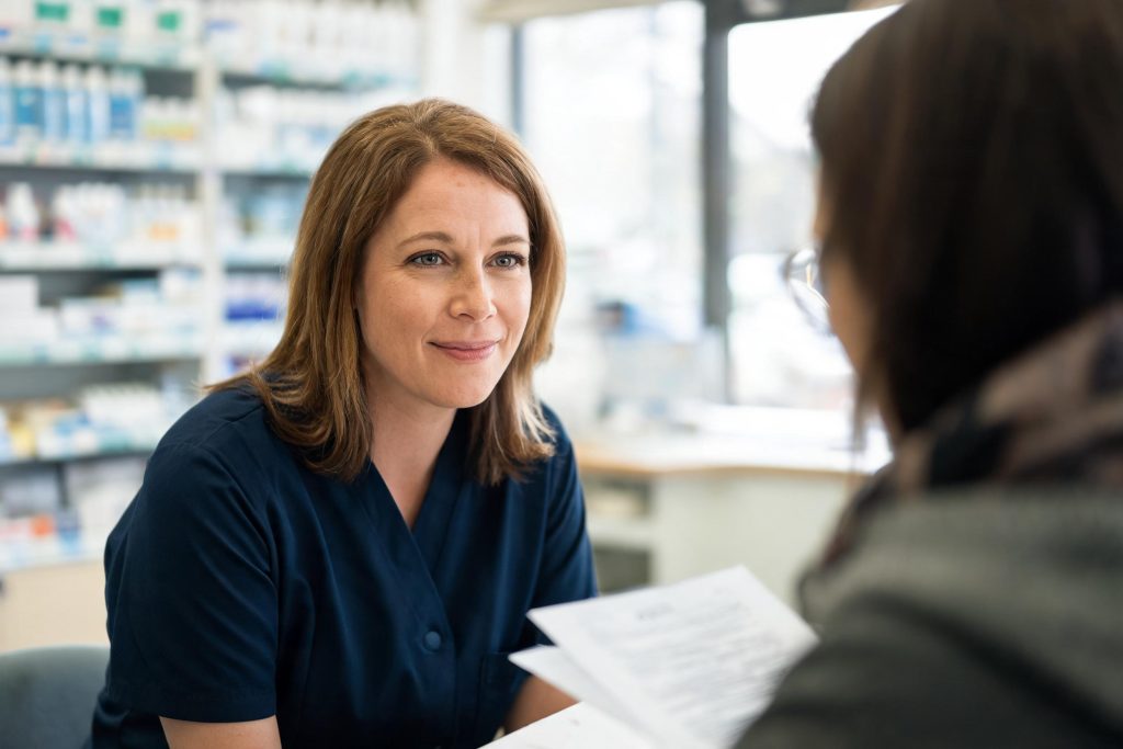 Pharmacist talking with a customer at the consultation counter
